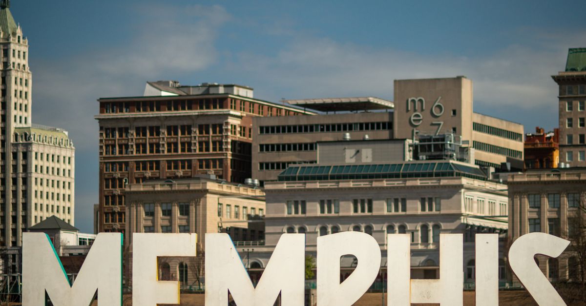 View of the Memphis sign set against the historic city skyline, showcasing iconic architecture.